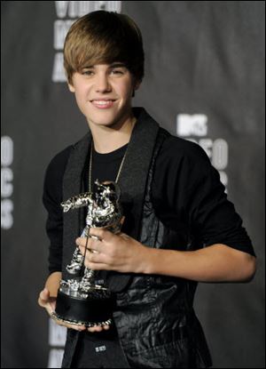 Teen pop sensation Justin Bieber smiles with his award for best new artist.