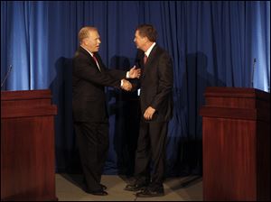 Ohio Gov. Ted Strickland and challenger John Kasich greet one another before the start of the debate at COSI in Columbus. 