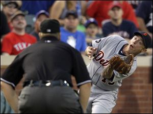 Tigers third baseman Brandon Inge reaches to make a catch of a foul popup in Wednesday night's game at Texas.