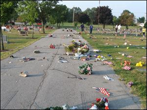 Vandals toppled headstones at McPherson Cemetery and threw flowers and other mementos placed at grave sites onto driveways.