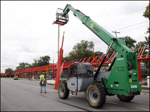 Slug:  CTY ZOO17p Date:  09172010   The Blade/Andy Morrison       Location:  Toledo Lake Caption:  Workers move a support piece into place for a new covered walkway at the Toledo Zoo, Friday, 09172010.       Summary:  EDS., I couldn't find Cyndi Condit of the zoo's PR staff, or get ahold of her by phone for more info.
