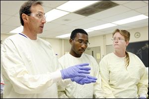 Mark Hankin, left, instructs students Robert Bell and Hope Dundas.