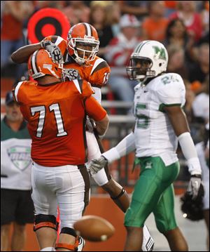 Bowling Green's Chip Robinson (71) and Kamar Jorden celebrate Jorden's touchdown as Marshall's Devin Arrington walks away in Saturday night's game.