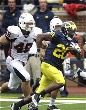 Michigan running back Michael Shaw runs away from the UMass defense in the fourth quarter. 