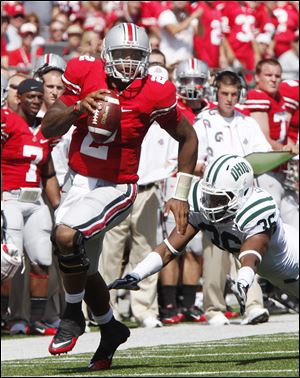 Ohio State quarterback Terrelle Pryor runs past the Bobcats' Stafford Gatling. Pryor completed 16 straight passes, a school record.