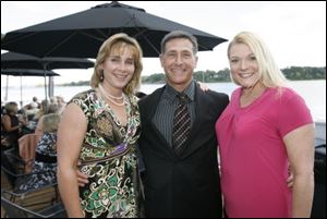 Sandy Woodford-Stober, left, her husband Jeff Stober, and Shannon Eisenbrandt enjoyed the Toledo Ski Club fall cocktail party.