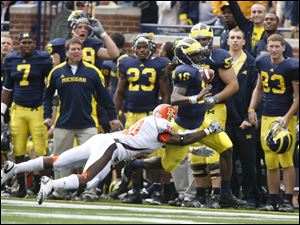 Michigan's Denard Robinson is forced out of bounds by Bowling Green's Ryland Ward in the first quarter. Robinson was hurt on the play and did not return, but he still had 129 yards rushing. Tate Forcier escapes the grasp of Bowling Green's Chris Jones.
The Wolverines piled up 721 yards of offense.