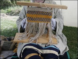 Kathy Holsinger of Wauseon weaves twine to make a bag during a demonstration.