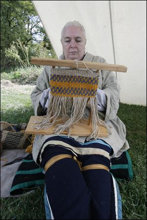 Kathy Holsinger of Wauseon weaves twine to make a bag during a demonstration.