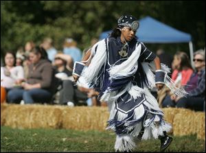 Jeremiah Tohannie, 11, of Elida, Ohio, performs a prairie dance at Buttonwood Park. The burpose of the dance is to flatten tall grasses so the reset of the celebration can proceed.