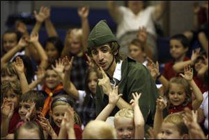 Tyler Pistoris entertains children at St. Pius X School.