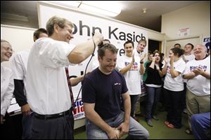 Slug: CTY shaving01p  Date: 09302010  The Blade/Andy Morrison   Location: Toledo Caption: Lucas County Republican Party Chairman Jon Stainbrook shaves the head of Mike Hartley, deputy campaign manager for John Kasich, at the party headquarters, Thursday, 09302010.