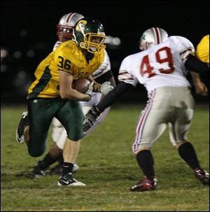 Clay's Kevin Gaskins looks to get past Central Catholic's Ronnie Sanner. The Irish limited Clay to 72 total yards.