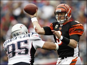 Bengals quarterback Carson Palmer is pressured by Patriots linebacker Tully Banta-Cain. Palmer
says adjusting to new players has contributed to the Bengals' offensive problems.