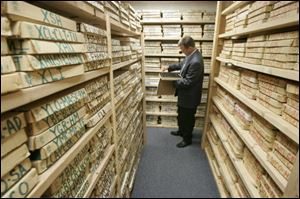 Ken Krieg, director of sales for Vintage Aerials, looks at boxes of old film in the company's vault. 