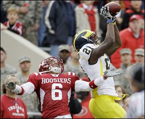 Michigan wide receiver Junior Hemingway makes a reception late in the game against Indiana's Richard Council to set up the game-winning touchdown.