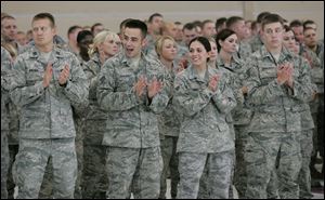 Members of the 180th Fighter Wing of the Ohio Air National Guard applaud their family members during a celebration to honor 22 ‘hometown heroes' at Toledo Express Airport.