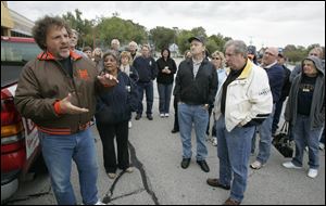 Steve Magnatta, left, and other Food Town ex-employees voice displeasure with congressional candidate Rich Iott, who led the chain when it was sold in 2000. Food Town was closed in 2003.