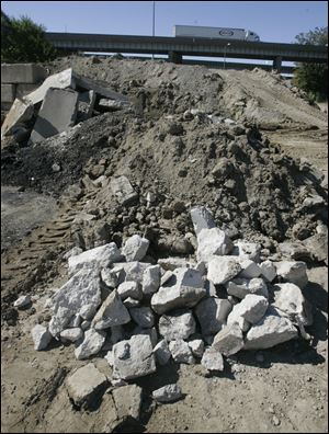 The city deposits fill dirt from water and sewer projects  near the I-75 overpass at Collingwood Boulevard.