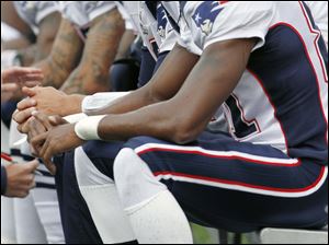 Randy Moss, right, sits next to Patriots quarterback Tom Brady. Moss had just nine catches in four games this season for 139 yards and 3 TDs. 