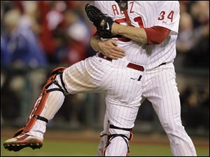 Philadelphia's Roy Halladay celebrates with catcher Carlos Ruiz after the Phillies defeated the Reds 4-0. Halladay, who struck out eight, tossed the second postseason no-hitter in history.