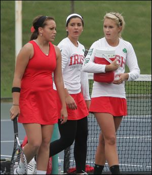 Anna Scherting, left, talks with the doubles team of Maria Mitchell, center, and Shannon O'Hearn following a match.  Scherting is 21-1 in singles. Mitchell and O'Hearn have a 17-3 record.
