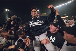 New York Yankees manager Joe Torre gets carried off the field after winning against the New York Mets in 2000.