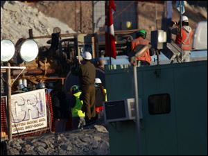 Workers involved in the operations to rescue 33 trapped miners are seen taking pictures in the San Jose Mine near Copiapo, Chile.