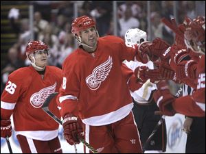Detroit's Mike Modano is congratulated by his teammates after scoring a goal in the first period.