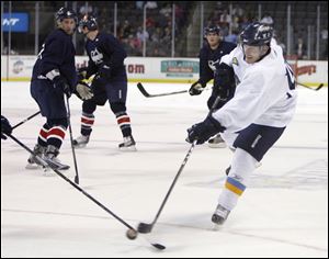 The Walleye's John May works his way through the Kalamazoo defense to get off a shot Saturday night against the Wings. Toledo opens its season Friday in Kalamazoo.