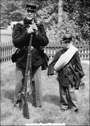 Rich Iott and son Ian wear Union uniforms as Civil War re-enactors. Mr. Iott has been involved in re-enacting various wars since the 1970s, his campaign said.
