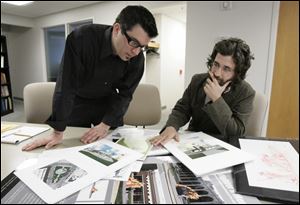 Marc Folk, executive director of the Arts Commission of Greater Toledo, left, and Adam Russell, the art in public places coordinator, look over the various designs in 2007.