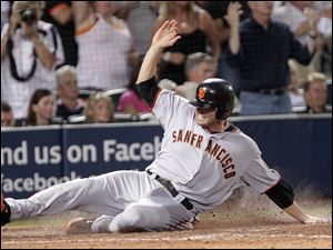 San Francisco's Freddy Sanchez slides in home with the go-ahead run against the Atlanta Braves on a ball hit by Buster Posey in the ninth inning. The Giants can win the series tonight.