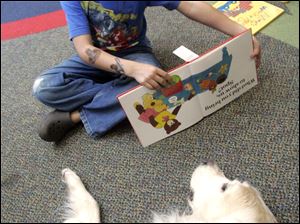Kyle Roessle, 6, of Temperance reads to Finnie. 