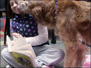 Porsche gives kisses to Isabella Becker, 8, of Temperance.
