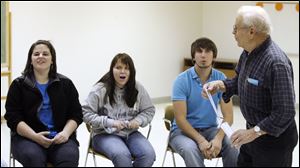 Students, from left, Emily Lust, Taylor Heier, and Ben Blake react to Charles Dreps' score.