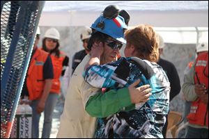 Johnny Barrios Rojas, 50, embraces his mistress Susana Valenzuela after his rescue. While he was trapped underground, his wife found out about his girlfriend when the two met at Camp Hope. His wife was not there to greet him.