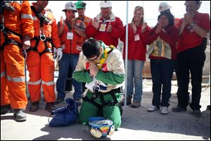 Miner Esteban Rojas, 44, gets to his knees to pray after his rescue. He proposed a church wedding ‘once and for all' in a message to the woman he married in a civil ceremony 25 years ago.
