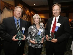Award winners Gary Yoder, left, Martha Vetter, and Bob Bortel are all smiles after the Touchstone Awards ceremony sponsored by the Toledo Press Club at the Toledo Club. 
