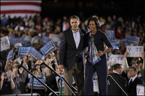President Obama and First Lady Michelle Obama survey the crowd of 35,000 at a rally for Democrats at Ohio State University. 