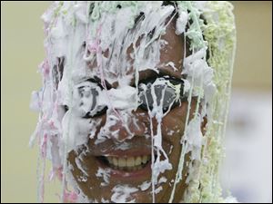 Sylvan Elementary School Principal John Duwve manages to smile through gobs of shaving cream and Silly String piled on by his students.