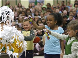 Slug: NBRW PIE20p  Date: 10142010  The Blade/Andy Morrison   Location: Sylvania Caption: Cameron Duvall, left, Ta'Lyr Borum and Taylir Lynam cover principal John Duwve in Silly String at  Sylvan Elementary School in Sylvania, Friday, 10152010. The students raised more than $16,500 this year in an annual effort to raise money for field trips and other activities. Top fund-raisers were rewarded by dousing their principal with Silly String and shaving cream.