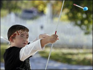 Dylan Logan, 9, of Maumee learns how to shoot a soft-tipped arrow. 