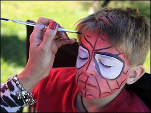 Taking up a Halloween costume theme, Jack Boeh, 9, of Maumee has his face painted to look like Spiderman.