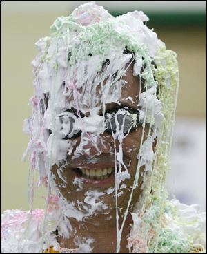 Sylvan Elementary School Principal John Duwve manages to smile through gobs of shaving cream and Silly String piled on by his students.