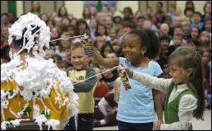 Slug: NBRW PIE20p  Date: 10142010  The Blade/Andy Morrison   Location: Sylvania Caption: Cameron Duvall, left, Ta'Lyr Borum and Taylir Lynam cover principal John Duwve in Silly String at  Sylvan Elementary School in Sylvania, Friday, 10152010. The students raised more than $16,500 this year in an annual effort to raise money for field trips and other activities. Top fund-raisers were rewarded by dousing their principal with Silly String and shaving cream.