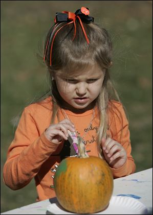 Marina Speweik, 5, of Lambertville, paints a pumpkin at the Fall Family Festival.