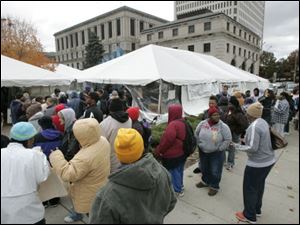 People wait in line to get free clothing during the 2009 1Matter Tent City.