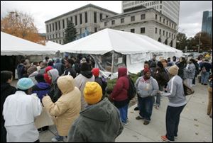 People wait in line to get free clothing during the 2009 1Matter Tent City.