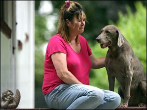 Rachel Hill Barton, with her dog Bob in July, 2009, says she has missed her sister every day since Lori Ann disappeared after a Halloween party in 1985. The 14-year-old's beaten body was discovered by a hunter four days after she vanished. Mrs. Barton still holds hope that she will see justice.